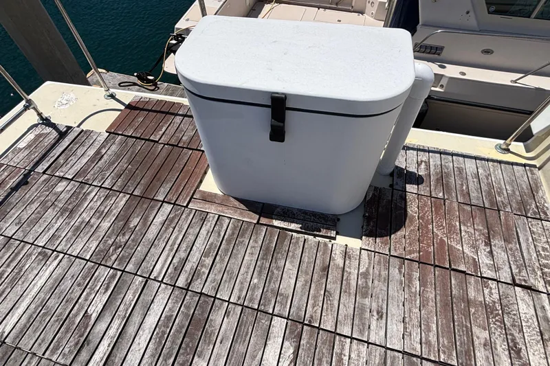 Slide: The Image of Wooden deck on a 1974 Skookum 34 boat with a white storage box. - 13