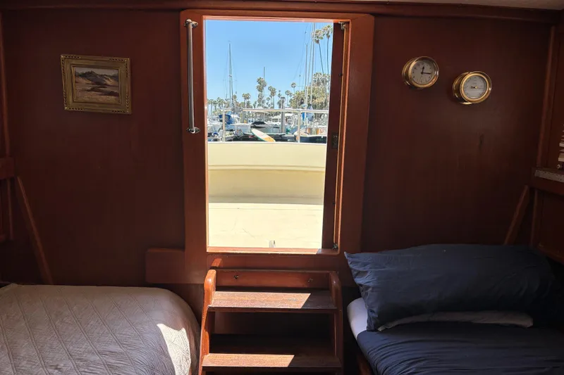 Slide: The Image of Cozy cabin interior of a 1974 Skookum 34 boat with marina view. - 17