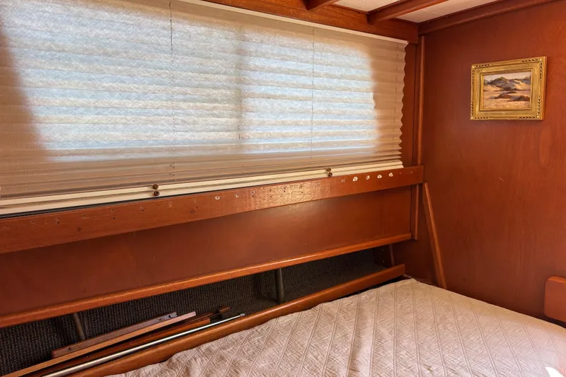 Slide: The Image of Interior of a 1974 Skookum 34 boat with wooden paneling and a small framed painting. - 21