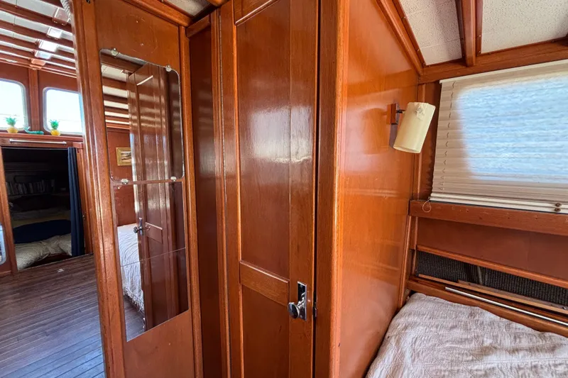 Slide: The Image of Interior of a 1974 Skookum 34 boat with wooden paneling and cozy sleeping area. - 22