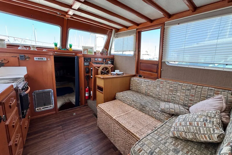 Slide: The Image of Interior of a 1974 Skookum 34 boat with cozy seating and wooden accents. - 26