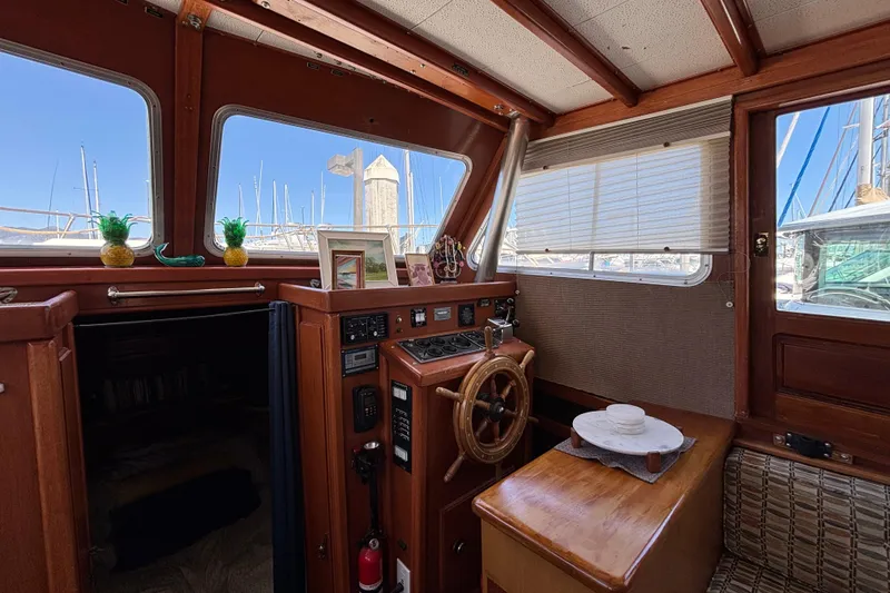 Slide: The Image of Interior of a 1974 Skookum 34 boat with wooden helm and nautical decor. - 29