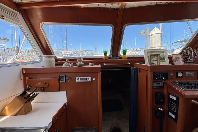 Slide: The Image of Interior of a 1974 Skookum 34 boat with wooden cabinetry and nautical decor. - 30