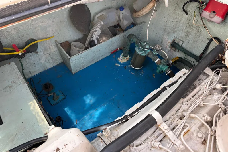 Slide: The Image of Engine compartment of a 1974 Skookum 34 boat, featuring mechanical components and storage. - 40