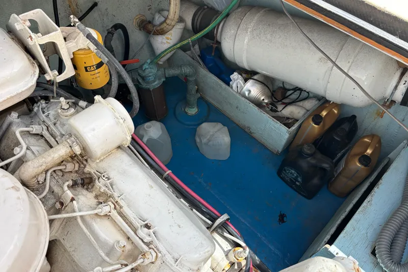 Slide: The Image of Engine compartment of a 1974 Skookum 34 boat with various mechanical components. - 41