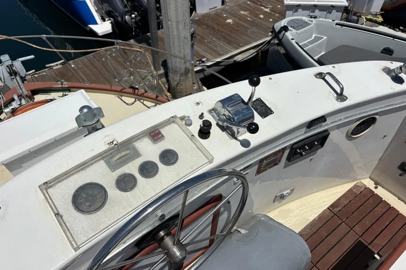 Slide: The Image of Cockpit of a 1974 Skookum 34 boat with steering wheel and control panel. - 9