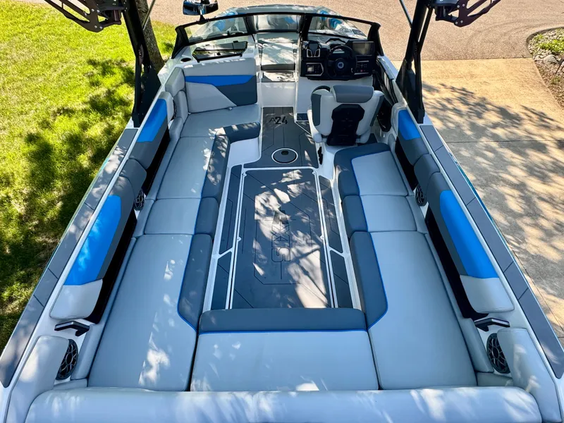 Slide: The Image of Interior of a 2022 Axis Wake Research A24 boat with blue and gray seating. - 1