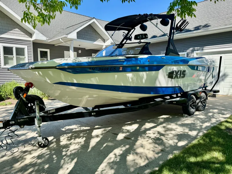 Slide: The Image of 2022 Axis Wake Research A24 boat on trailer in driveway. - 11