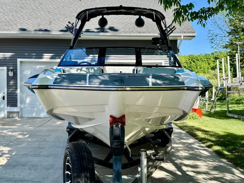 Slide: The Image of 2022 Axis Wake Research A24 boat on trailer in driveway. - 12