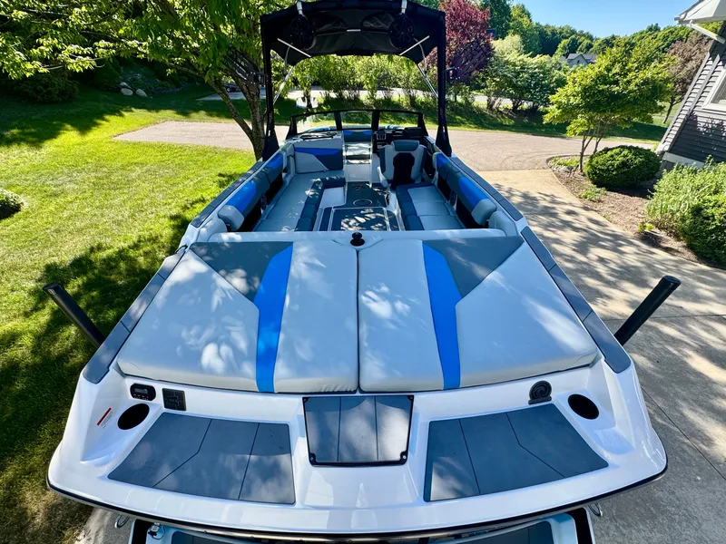 Slide: The Image of 2022 Axis Wake Research A24 boat with blue-gray upholstery outdoors. - 15