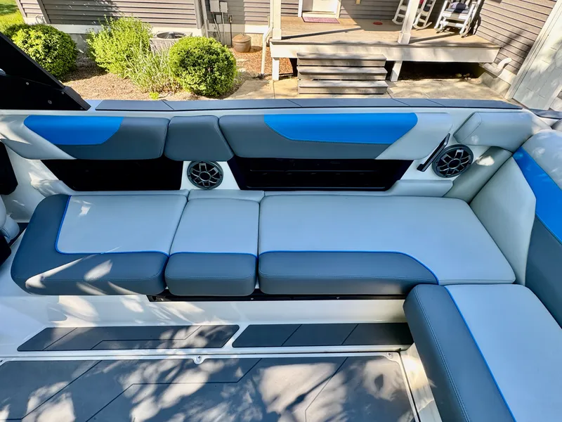 Slide: The Image of Interior of a 2022 Axis Wake Research A24 boat with blue and gray seating. - 25