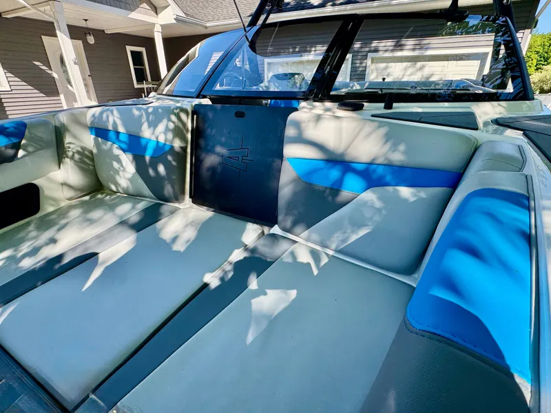Slide: The Image of Interior of a 2022 Axis Wake Research A24 boat with blue accents. - 3
