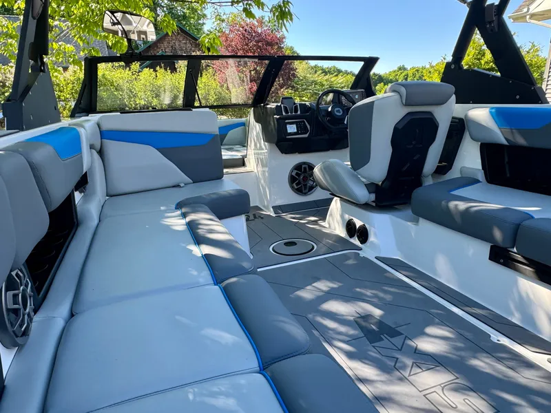 Slide: The Image of Interior of a 2022 Axis Wake Research A24 boat with gray and blue seating. - 30