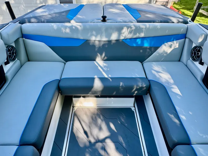 Slide: The Image of Interior of a 2022 Axis Wake Research A24 boat with blue accents. - 31