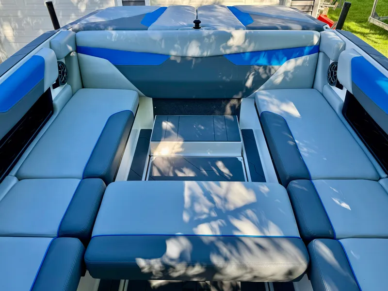 Slide: The Image of Interior of a 2022 Axis Wake Research A24 boat with blue accents. - 33