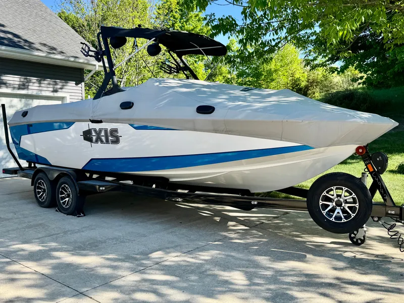 Slide: The Image of 2022 Axis Wake Research A24 boat on trailer outdoors. - 45