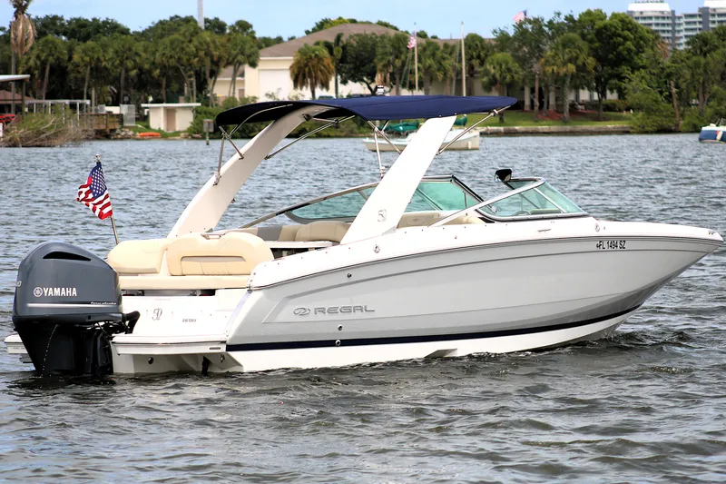 Slide: The Image of 2021 Regal 26 OBX boat with Yamaha engine on a scenic lake. - 1