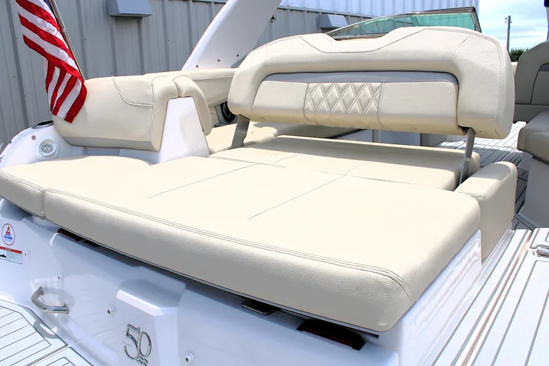 Slide: The Image of 2021 Regal 26 OBX boat with beige seating and American flag. - 11