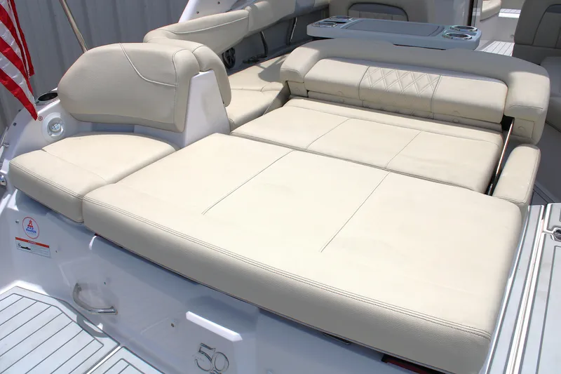 Slide: The Image of 2021 Regal 26 OBX boat with beige leather seating and American flag. - 12