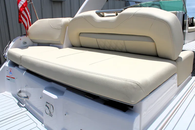Slide: The Image of 2021 Regal 26 OBX boat with beige seating and American flag. - 13