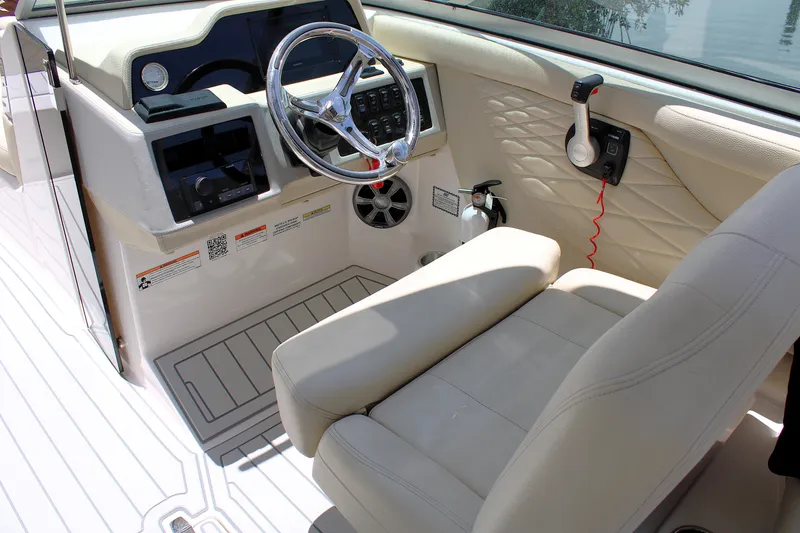 Slide: The Image of 2021 Regal 26 OBX boat cockpit with steering wheel and control panel. - 15