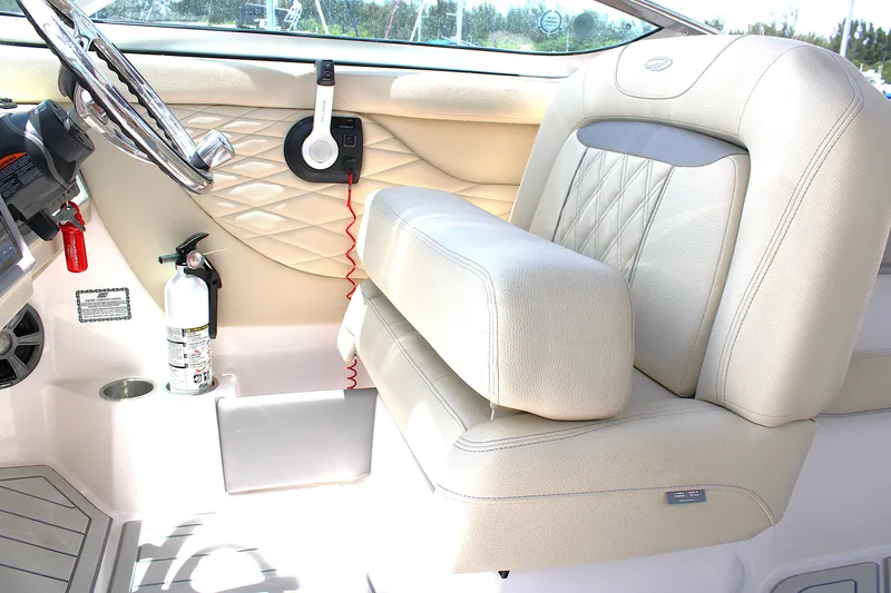 Slide: The Image of 2021 Regal 26 OBX boat interior with beige seating and steering wheel. - 16