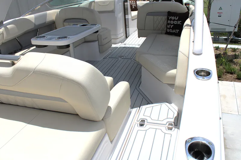 Slide: The Image of 2021 Regal 26 OBX boat interior with beige seating and table. - 19