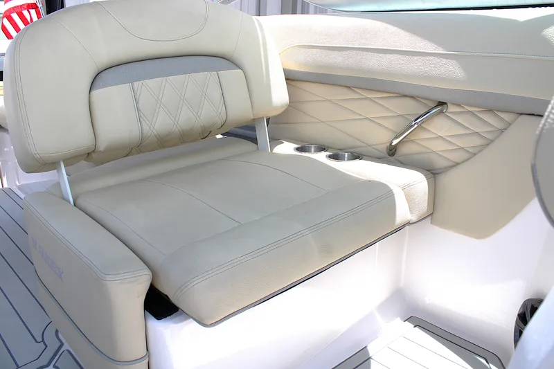 Slide: The Image of Luxurious beige seating on 2021 Regal 26 OBX boat with cup holders and quilted design. - 21