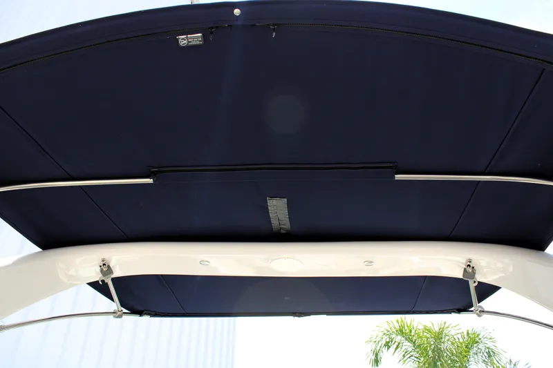 Slide: The Image of 2021 Regal 26 OBX boat canopy, featuring a sleek navy blue design and sturdy metal frame. - 27