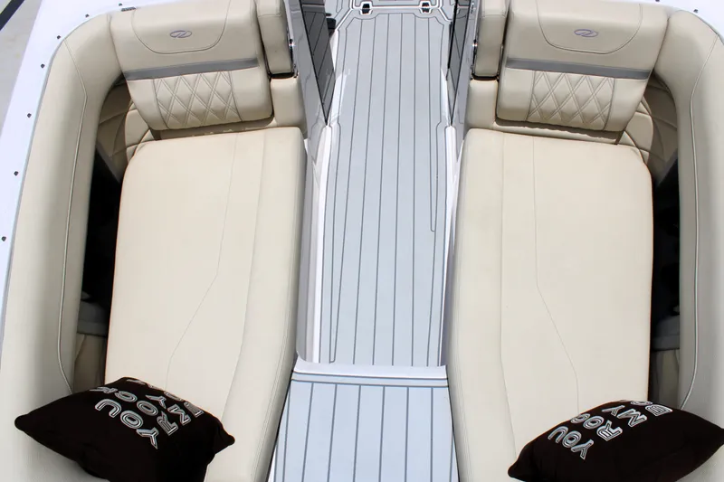 Slide: The Image of 2021 Regal 26 OBX boat interior with beige seating and decorative pillows. - 31