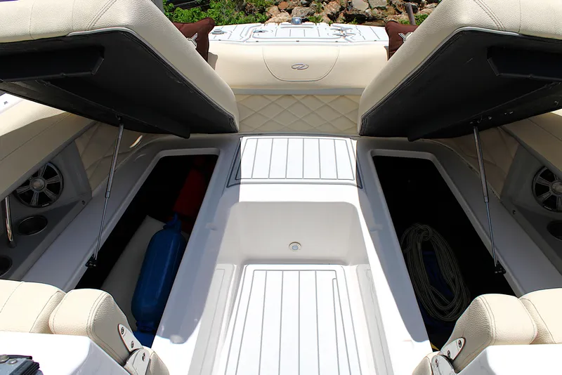 Slide: The Image of 2021 Regal 26 OBX boat interior with open storage compartments and seating. - 32