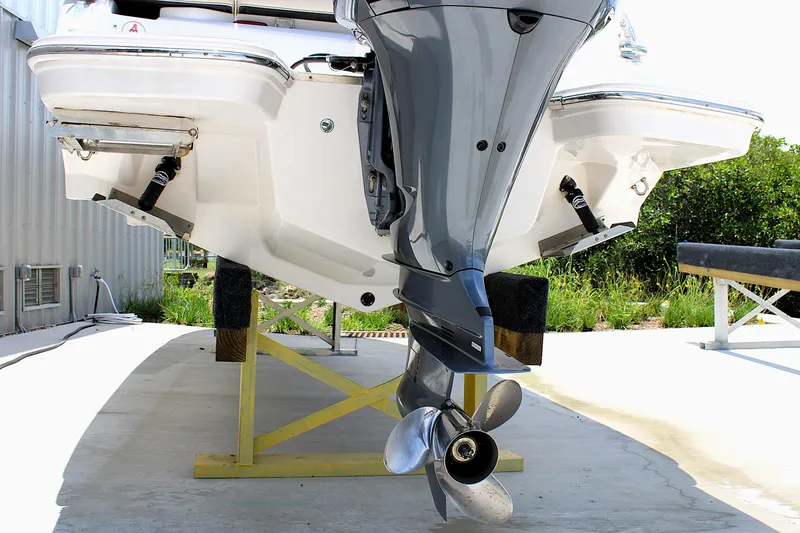 Slide: The Image of 2021 Regal 26 OBX boat with outboard motor on a stand, rear view. - 36