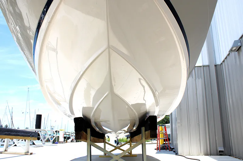Slide: The Image of 2021 Regal 26 OBX boat hull on display at a marina. - 38