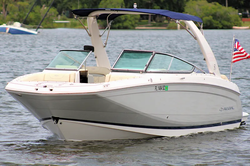 Slide: The Image of 2021 Regal 26 OBX boat on a lake with American flag, sunny day. - 5