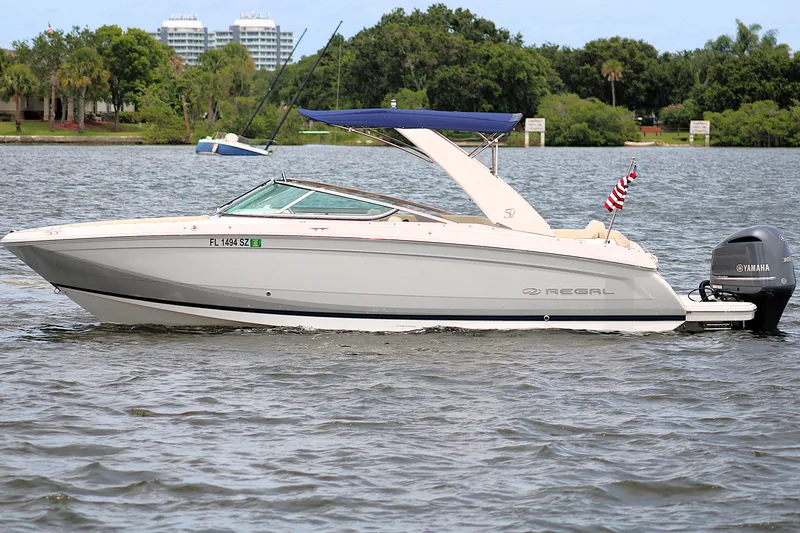 Slide: The Image of 2021 Regal 26 OBX boat with Yamaha engine on a calm lake. - 6