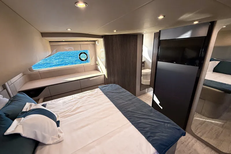 Slide: The Image of Luxurious bedroom interior of 2027 Cruisers Yachts 50 Fly with ocean view window. - 44