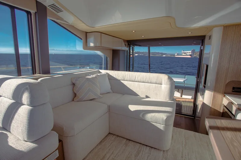 Slide: The Image of Luxurious interior of 2027 Cruisers Yachts 50 Fly with ocean view through large windows. - 20