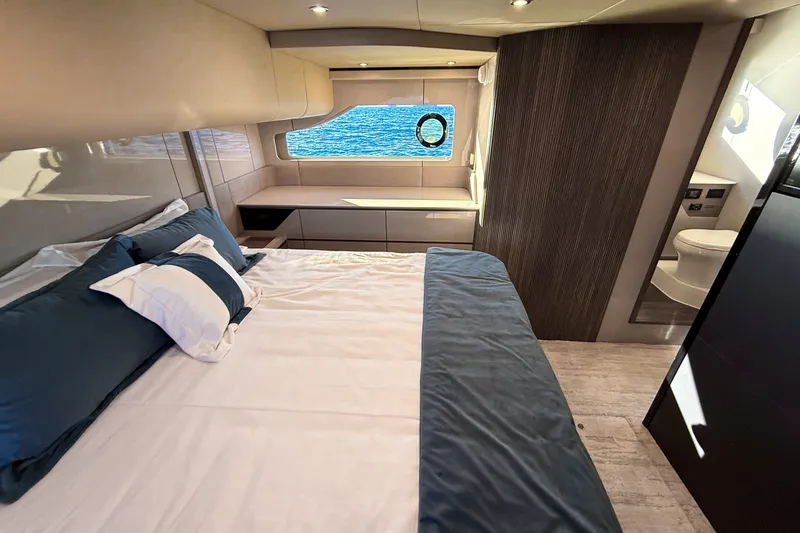 Slide: The Image of Luxurious bedroom interior of 2027 Cruisers Yachts 50 Fly with ocean view window. - 43