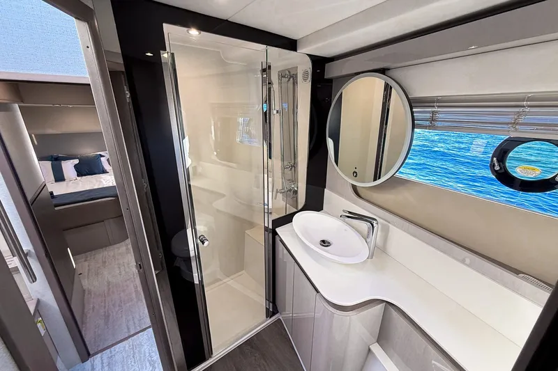 Slide: The Image of Luxurious bathroom interior of 2027 Cruisers Yachts 50 Fly, featuring modern fixtures and ocean view. - 34