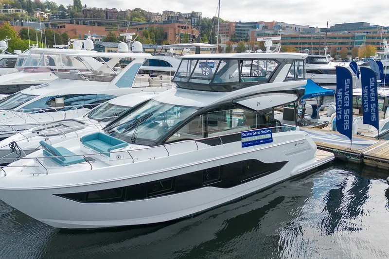 Slide: The Image of 2027 Cruisers Yachts 50 Fly docked at marina, showcasing sleek design and modern features. - 17