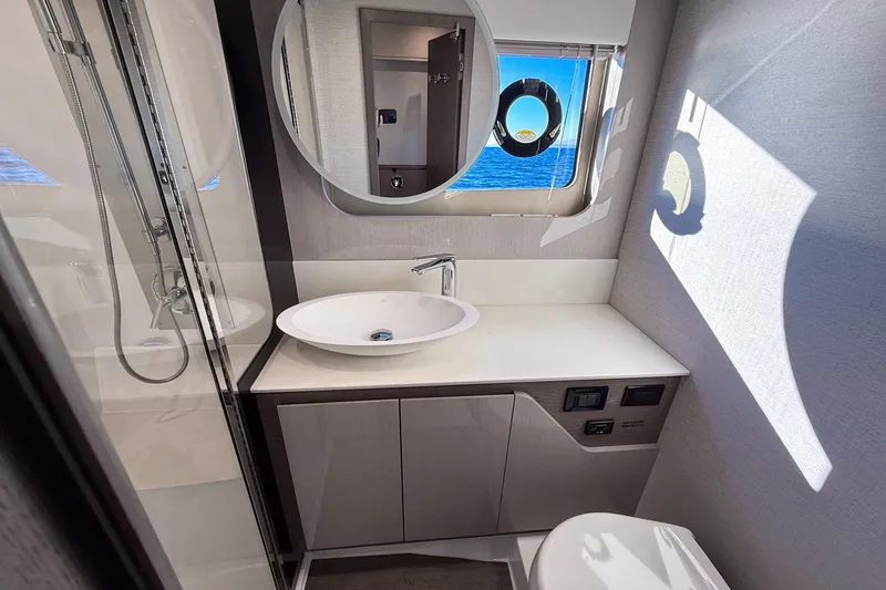 Slide: The Image of Luxurious bathroom in 2027 Cruisers Yachts 50 Fly, featuring modern fixtures and ocean view. - 37