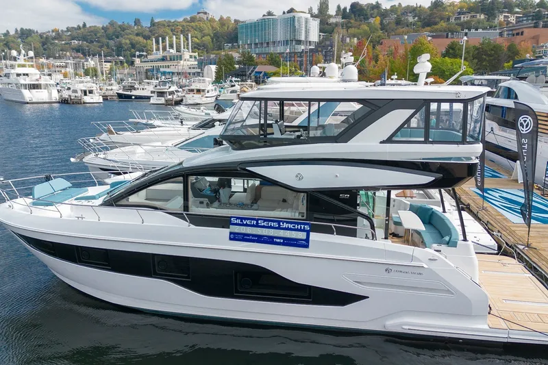 Slide: The Image of 2027 Cruisers Yachts 50 Fly docked at marina, showcasing sleek design and modern features. - 2