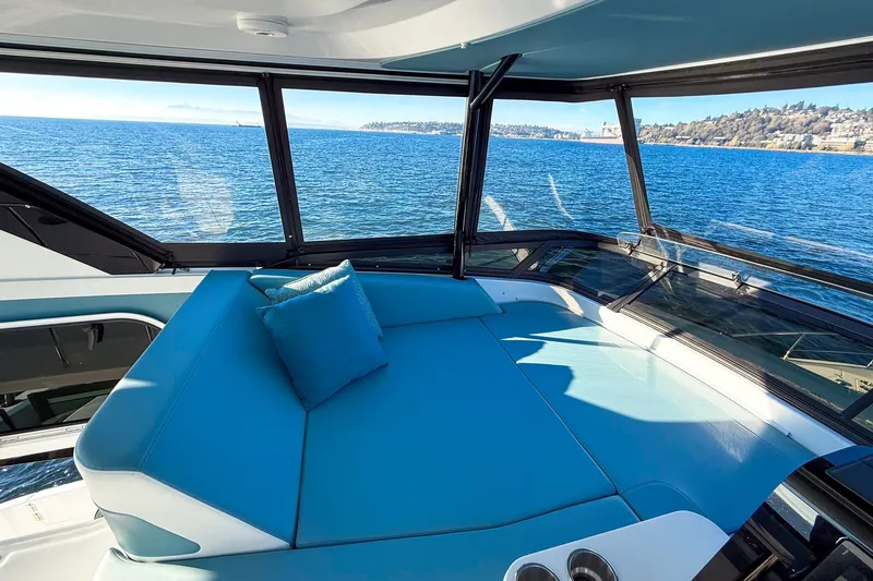 Slide: The Image of Luxurious interior of 2027 Cruisers Yachts 50 Fly with ocean view and plush seating. - 50