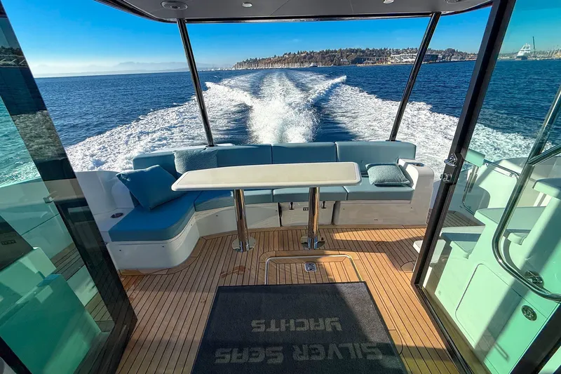 Slide: The Image of Luxurious 2027 Cruisers Yachts 50 Fly with elegant seating and scenic ocean view. - 24