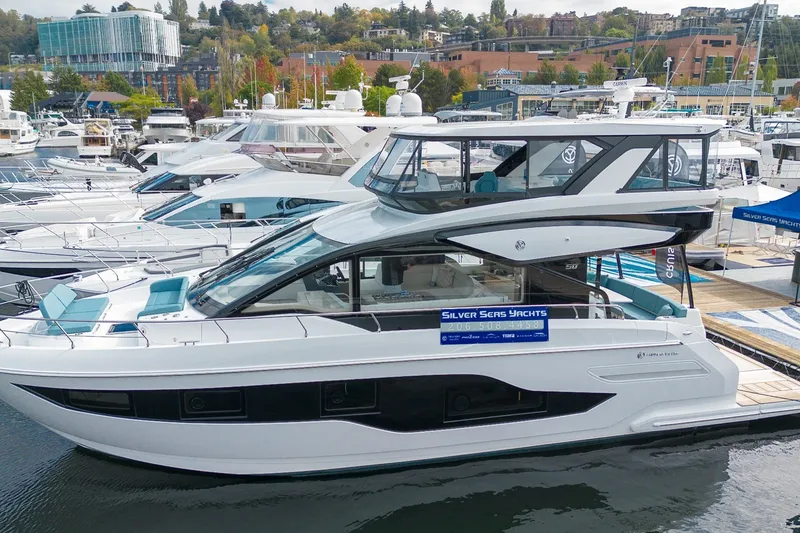 Slide: The Image of 2027 Cruisers Yachts 50 Fly docked at marina, showcasing sleek design and modern features. - 16