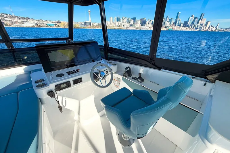 Slide: The Image of Helm of 2027 Cruisers Yachts 50 Fly with city skyline view. - 49