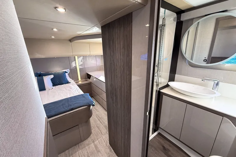 Slide: The Image of Luxurious interior of 2027 Cruisers Yachts 50 Fly, featuring a modern bedroom and bathroom. - 36