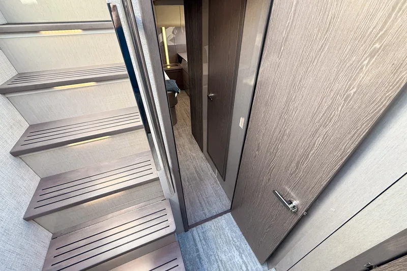 Slide: The Image of Interior view of 2027 Cruisers Yachts 50 Fly, featuring modern stairs and hallway design. - 35