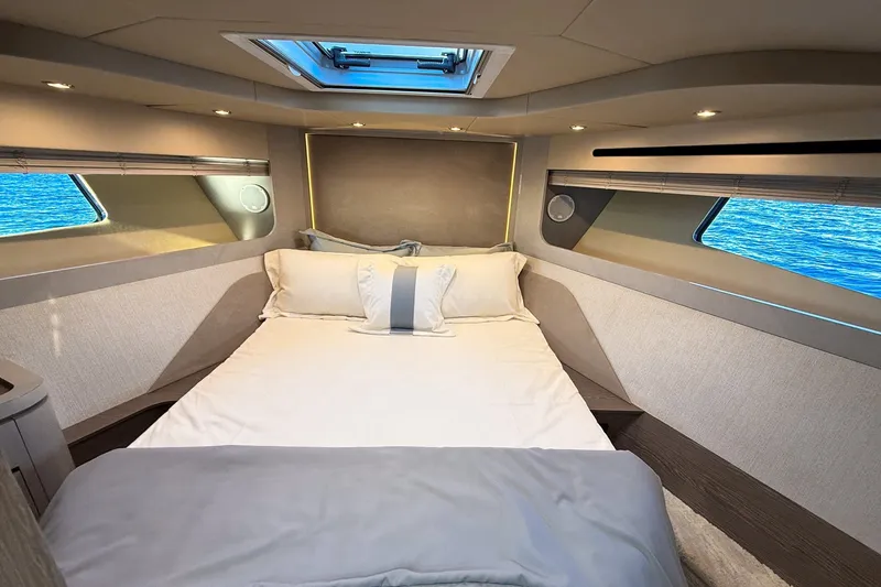 Slide: The Image of Luxurious bedroom interior of 2027 Cruisers Yachts 50 Fly, featuring elegant bedding and ocean view. - 31
