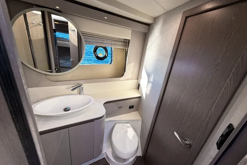 Slide: The Image of Modern bathroom interior of 2027 Cruisers Yachts 50 Fly, featuring sleek design and ocean view. - 32